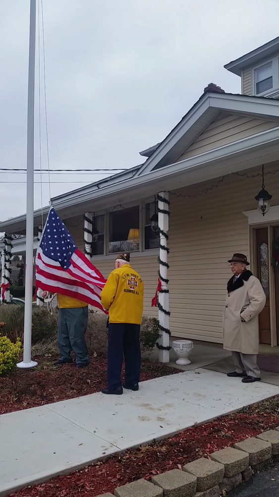 A picture of two man raising an American flag